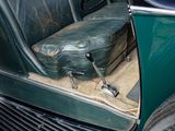 a suitcase sitting in the back seat of a green car