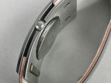 a close up of a watch sitting on top of a white surface