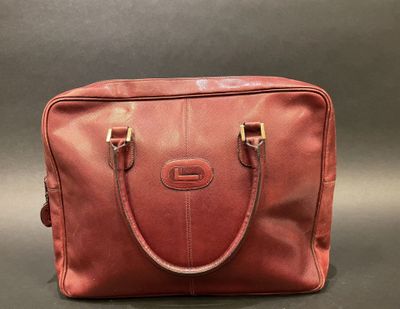 a red leather handbag on a grey background