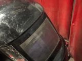 a welding helmet that is sitting on top of a table