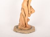 statue of a woman holding a bird on a pedestal