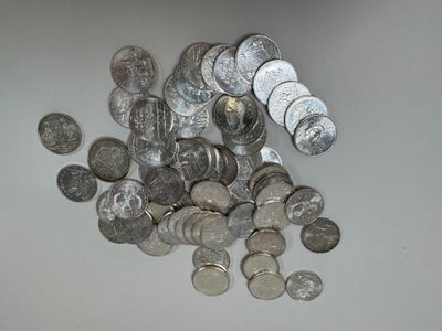 a pile of silver coins sitting on a table