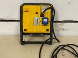 a yellow and black machine that is on the floor