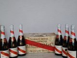 six bottles of beer are lined up in a row on a table