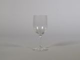 a empty wine glass sitting on a white surface