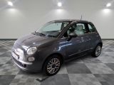the small grey car is parked in the garage on a checkered floor