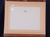 painting of a triangle on a white board on a wooden easel
