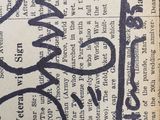 a piece of newspaper with a drawing of a cat on it