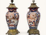 pair of antique chinese vases on stands with lamps on top of them