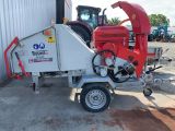 a red machine that is parked in front of a building