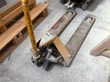 several pieces of wood are stacked on top of pallets in a warehouse