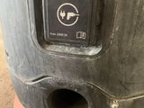the back end of an orange and black machine with a button on it