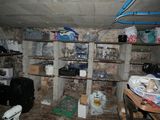 a room that has a bunch of items on the shelves