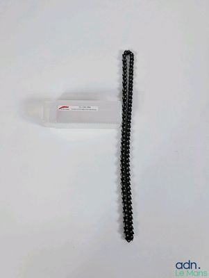 a close up of a black and white telephone on a white surface