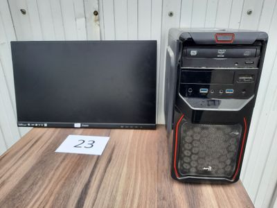 a desktop computer sitting on a desk next to a monitor