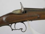 a close up of a rifle with a metal handle on a white background