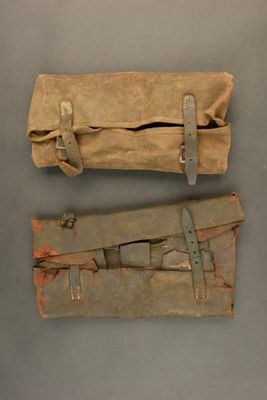two pieces of leather are sitting on a table next to each other