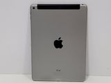 an apple ipad is sitting on a table with a white wall in the background