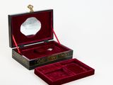 a small box with a mirror in it on a white surface