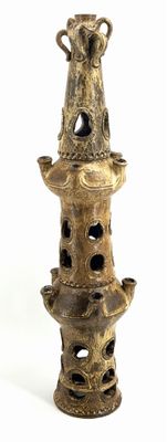 a picture of a tall vase with a bird on top of it