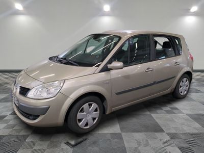 a picture of a small beige car parked in a garage
