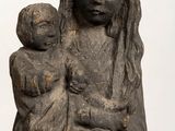 an old statue of a woman holding a child in her arms