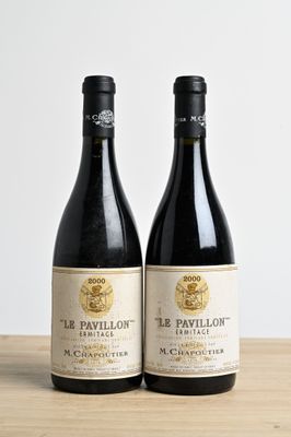 two bottles of wine sitting on top of a wooden table
