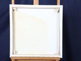 a easel with a painting on it and a blue background