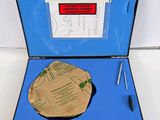 an open blue case with a piece of paper and a pen in it