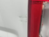 rear end of a white van with a red tail light