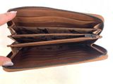 a person holding a wallet that is open on a white surface