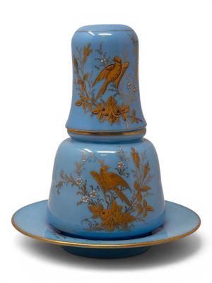 a blue and gold plate with a bird on it