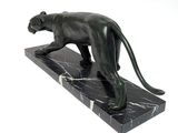 statue of a black panther on a marble base on a white background