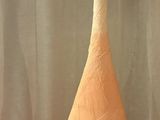 a large orange and white vase sitting on a table