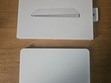 an apple magic trackpad is sitting on a table next to a box