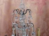 a crystal chandelier with candles on a table