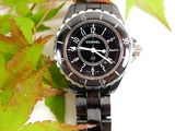 a picture of a watch sitting on a leafy surface
