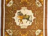 a brown and yellow scarf with a horse on it