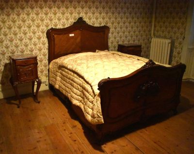 a bed that is in a room with a wooden frame