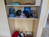 a closet with a lot of stuff on the shelves
