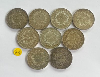 six different types of coins are arranged on a white surface