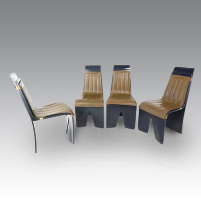 three chairs and a table in a room with a gray background