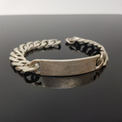 bracelet argenté et noir avec une chaîne sur un fond noir