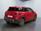 the red citrole is parked in a large room