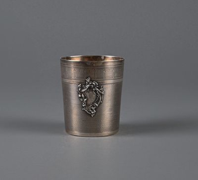 an antique silver cup with a lion emblem on the side