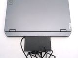 a laptop that is connected to a charger on the table