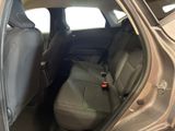 the back seat of a car with the door open and a seat belt down