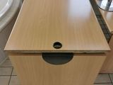 a wooden table with a drawer in the middle of it