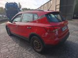 a red car that is parked in a parking lot
