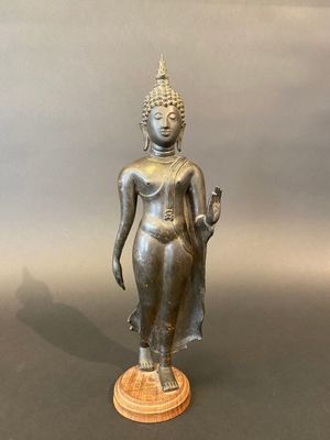 an image of a bronze statue of a woman holding a flower